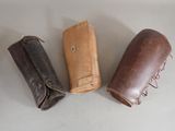 three leather cases that are sitting on a table