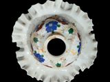 a close up of a white vase with blue flowers on it