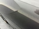 someone is peeling the paint off of a car ' s door handle
