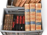 many old books in a box on a white surface