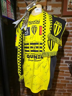 a mannequin wearing a yellow shirt with a scarf on it
