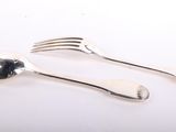 two spoons and a fork on a white surface