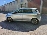 a picture of a silver car parked in front of a building
