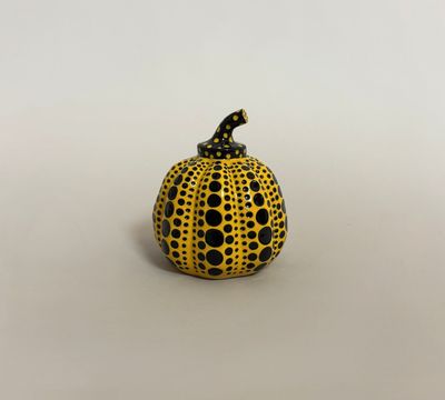 yellow and black polka dot pumpkin on white background
