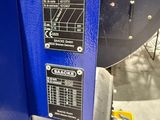 a close up of a blue machine in a factory