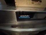 an image of a stainless steel dishwasher with a sign on it
