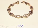 a picture of a bracelet and a tag on a table