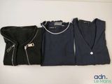three shirts are lined up next to each other on a table