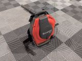 a red and black blower sitting on top of a checkered floor