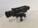 a close up of a small telescope on a tripod on a table