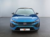 the front view of a blue car in a showroom