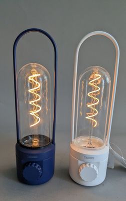 two lamps that are sitting next to each other on a table