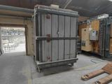 a large metal container in the middle of a warehouse