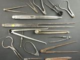 many different types of scissors and pliers on the table
