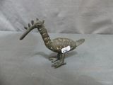 a small bronze bird with a tag on it ' s neck