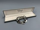 a close up of a bracelet in a box on a table