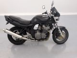 a black motorcycle that is parked in a room