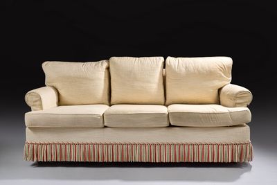 an image of a couch with pillows on it in a dark room