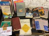 a lot of books on a table with a sign on it