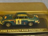 a toy car in a glass case on a table