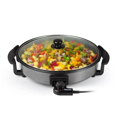 a close up of a pan with vegetables in it on a white surface