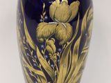 a blue vase with a gold design on it