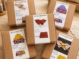 four boxes of craft kits sitting on top of a wooden table