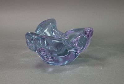 purple and blue glass bowl sitting on top of a table