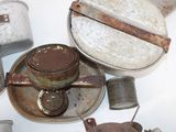 a lot of old tins and tin cans on the table