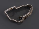 a bracelet with pearls and a clasp on a black surface