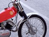 a red motorcycle parked on the side of the road