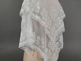 a white wedding veil on a mannequin head
