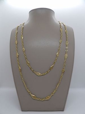 un collier à chaîne en or sur un mannequin, sur fond blanc
