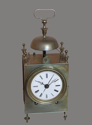 a silver clock with a bell on top of it