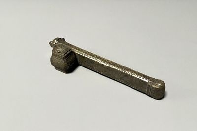 an image of a metal object on a white surface