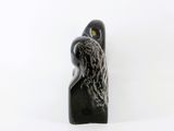 an image of a sculpture of a woman with a bird on her head