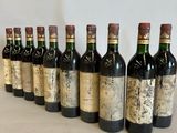 six bottles of wine are lined up in a row on a table