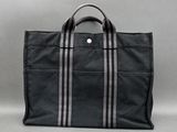 a black tote bag sitting on top of a table