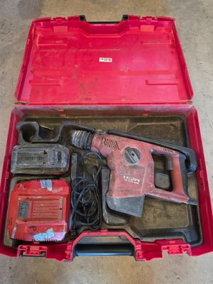an image of a red tool box filled with tools on top of a floor