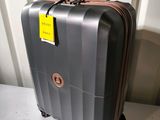 a suitcase with a tag on it sitting on a table