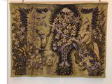 a tapestry hanging on the wall in a room