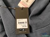 the label on the back of a gray suit is attached to the back of a gray suit