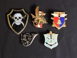 several different types of badges are displayed on a black surface