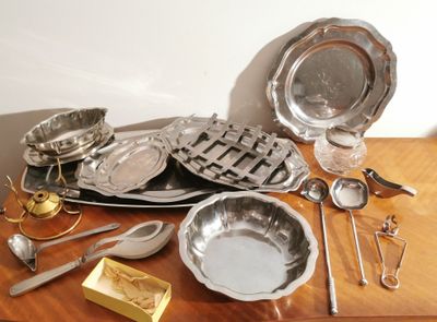 a wooden table with a lot of silverware on it