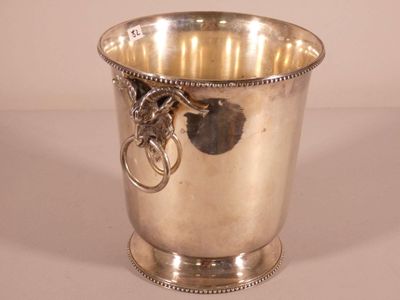 a silver cup with a key in it on a table