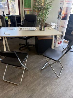 a desk with a chair and a computer on it