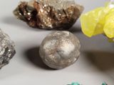 a lot of different colored rocks and stones on the table