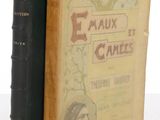 two old books sitting on a table next to each other