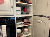 an image of a kitchen with white cabinets and a black stove