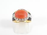 an orange coral and diamond ring on a white background